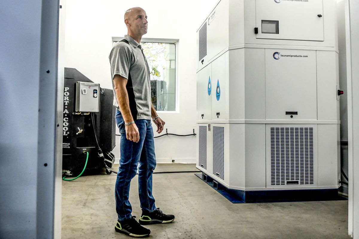 Tsunami Products CEO Kevin Collins stands next to one of the company’s atmospheric water generators. The company has sold 20 generators this year and received 20 additional orders in the past two weeks. (Kathy Plonka/The Spokesman-Review)