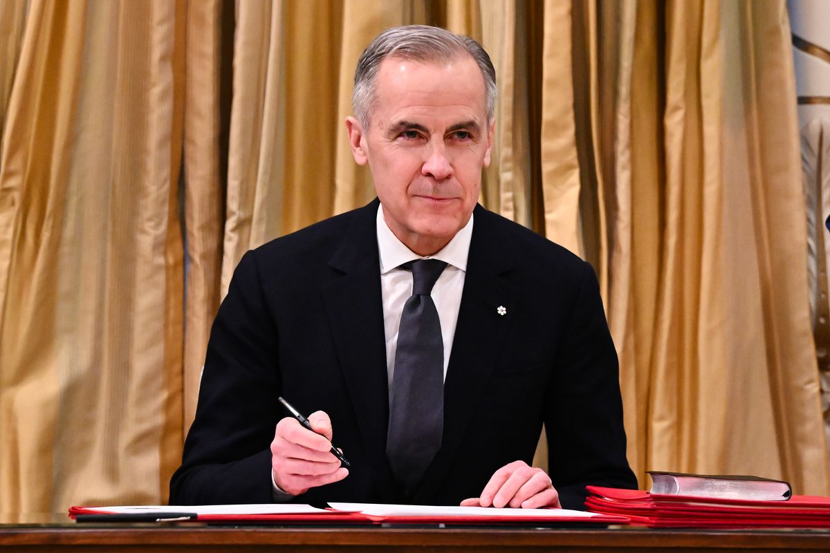 Mark Carney officially signs the Oath Book and the Instrument of Advice during his swearing-in ceremony as Canada’s 24th prime minister at Rideau Hall on Friday in Ottawa, Ontario, Canada. Carney, a former central banker, replaces Justin Trudeau as prime minister and Liberal Party leader as the country faces a trade war with the United States. (Minas Panagiotakis)