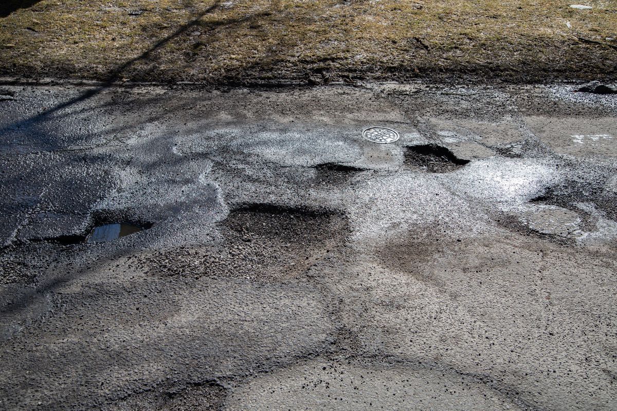 Potholes and imperfections are seen on the westbound lanes of the 1000 block of West Riverside Avenue in Spokane, Wash. on March 17, 2019. (Libby Kamrowski / The Spokesman-Review)