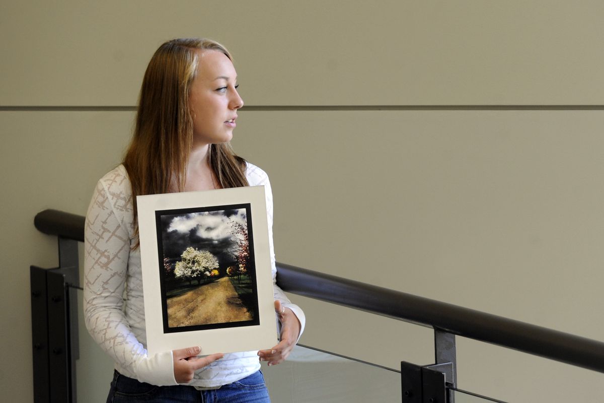 West Valley High School sophomore Tonya Lewis holds a print of her photo of a tree-lined path at Hutton Settlement that won an international photo contest. (Jesse Tinsley)