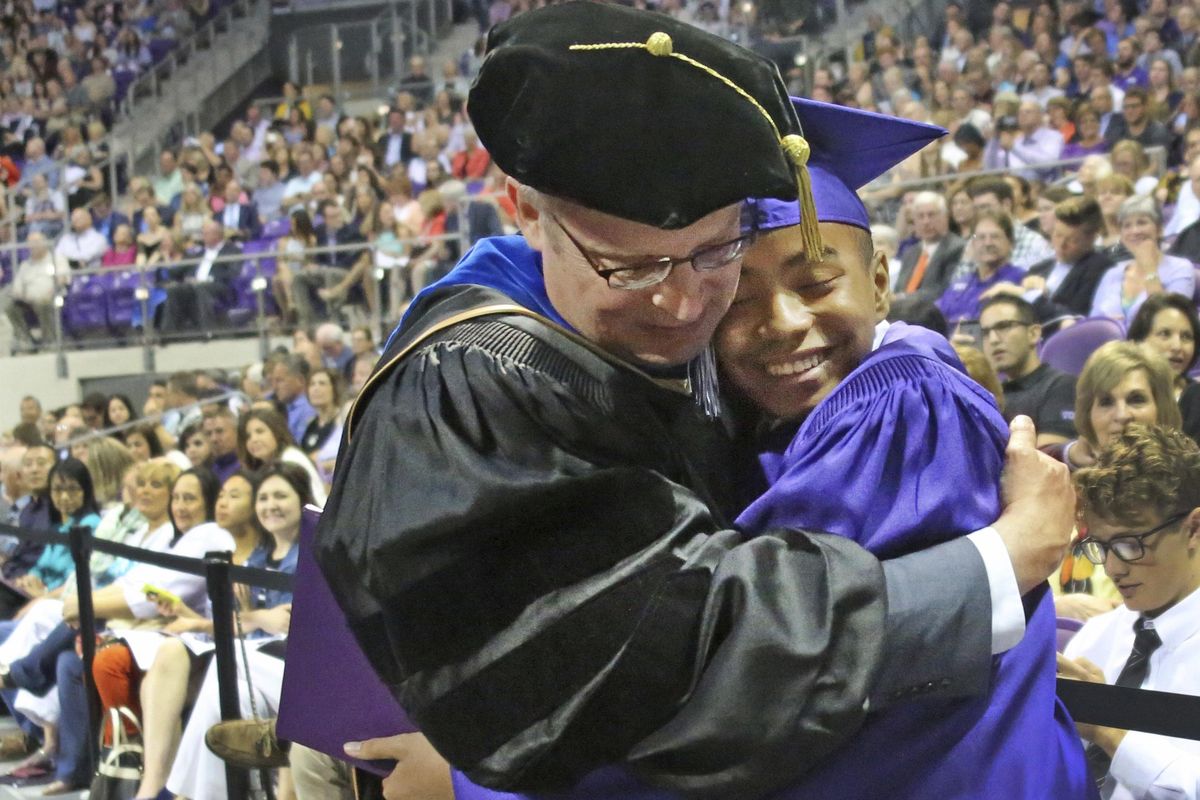 Fourteen year old Carson Huey-You gets a hug from his mentor, physics professor Magnus Rittby, after receiving a bachelor’s degree in physics at the Texas Christian University commencement held in Fort Worth on Saturday, May 13, 2017. Huey-You, the youngest student ever to attend TCU, also double-minored in math and Chinese since enrolling in 2013. (Louis DeLuca / The Dallas Morning News)