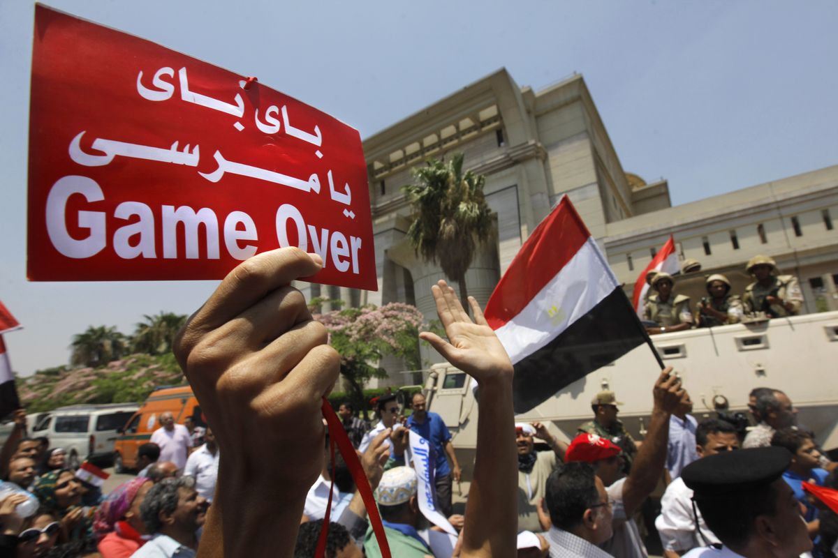 Egyptians celebrate in front of the constitutional court after Egypt’s chief justice Adly Mansour was sworn in as the nation’s interim president Thursday. (Associated Press)
