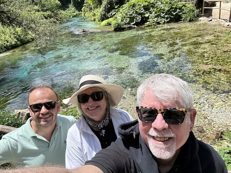 Martin, Mary Pat and I take a selfie overlooking Albania's Blue Eye (see a bather in the distance). (Dan Webster)