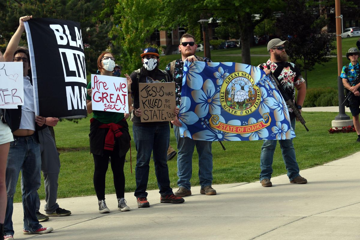 A group of protesters, including armed men in Hawaiian shirts, gather in front of Coeur d’Alene City Hall to protest the killing of George Floyd on Thursday, June 4, 2020. (Kathy Plonka / The Spokesman-Review)