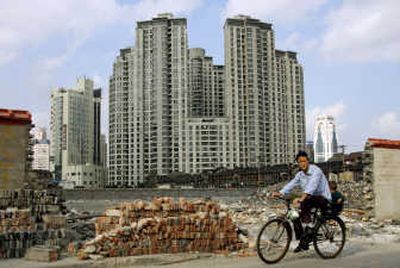 
A woman cycles past a site where apartments will be built in Shanghai, China. From China and South Korea to India and Singapore, housing prices are soaring amid strong economic growth and surging demand from developers and upwardly mobile families. Associated Press
 (Associated Press / The Spokesman-Review)