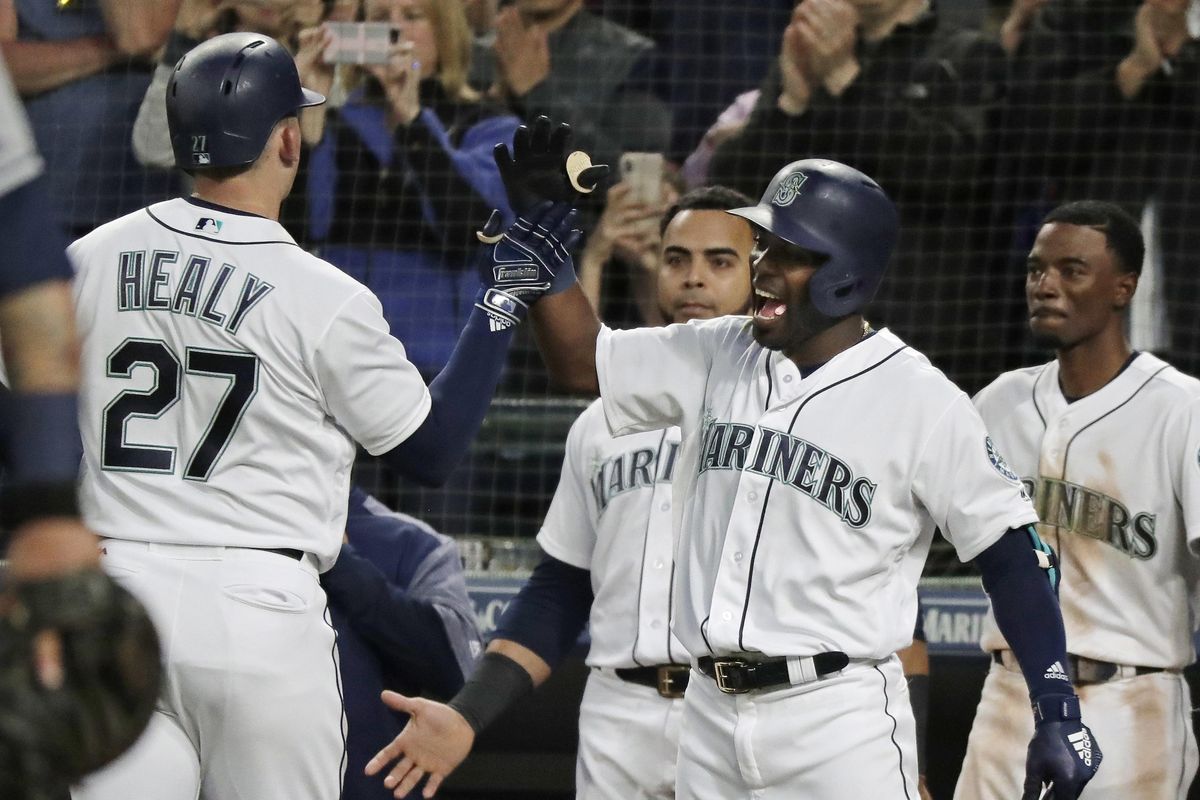 Seattle Mariners' Ryon Healy (27) is greeted at the dugout by Guillermo Heredia, second from right, after Healy hit a solo home run against the Tampa Bay Rays during the sixth inning of a baseball game Saturday, June 2, 2018, in Seattle. (Ted S. Warren / AP)