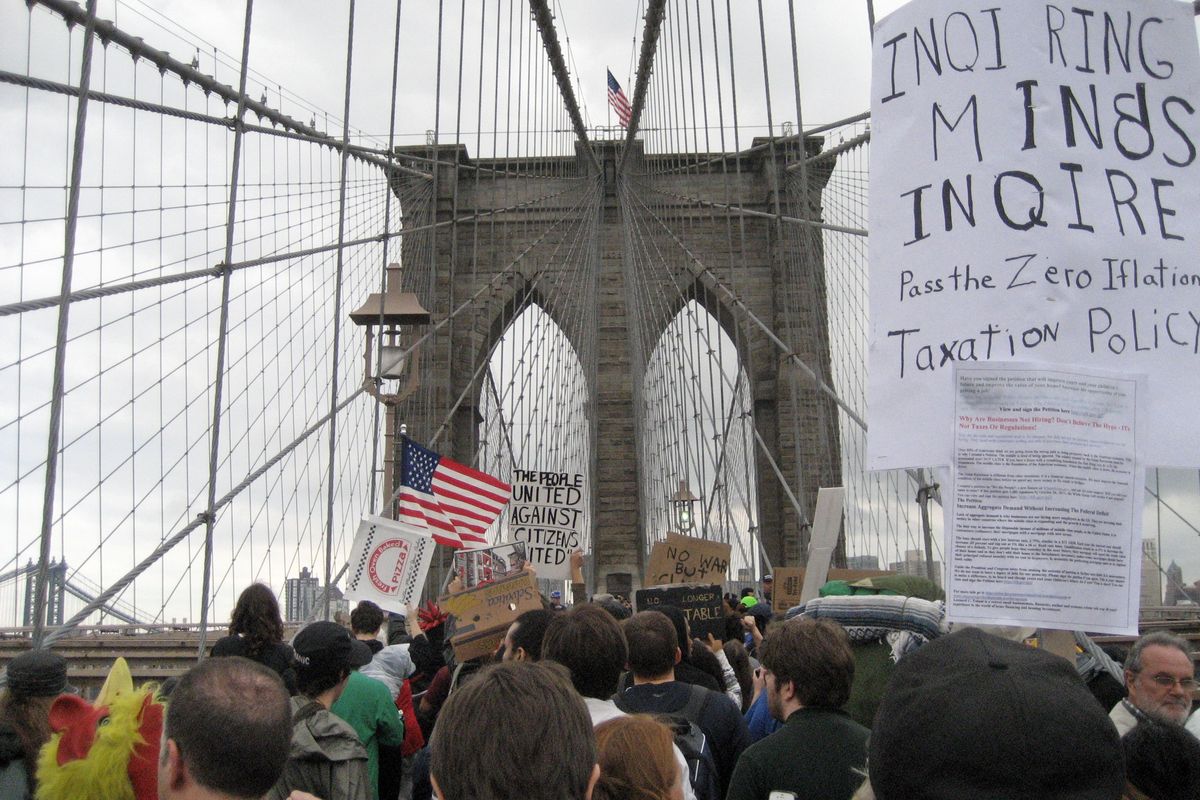 The large group of protesters who camped out on Wall Street for the past two weeks march across the Brooklyn Bridge roadway before being halted by police, Saturday, Oct. 1, 2011 in New York. Police arrested dozens while trying to clear the road and reopen for traffic. (Daryl Lang / Associated Press)