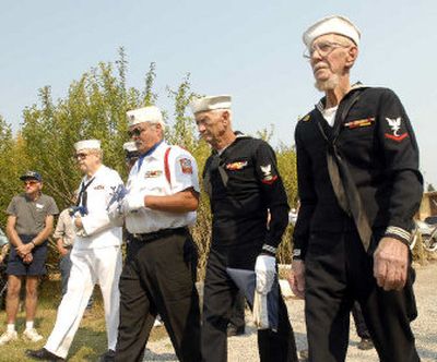
The color guard, made up of, from right, Tom Reilly, Leon Woodworth, Wayne Syth and Frank Johnson, marches to the flagpoles outside the museum at Farragut State Park on Friday to kick off the annual Farragut Naval Training Station reunion. 
 (Jesse Tinsley / The Spokesman-Review)