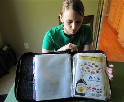 In this photo taken Tuesday, June 28, 2011, Monica Knight, a dental hygienist and mother of two, shows her coupon binder at her home in Boise, Idaho. Knight, used to spend spent $600 a month on groceries. Thanks to extreme couponing she's down to $100-150 a month. (AP Photo / Jessie L. Bonner)