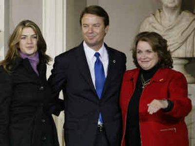 
Sen. John Edwards with his wife, Elizabeth, and their daughter Cate look to supporters following Sen. John Kerry's concession speech Wednesday at Faneuil Hall in Boston.
 (Associated Press / The Spokesman-Review)