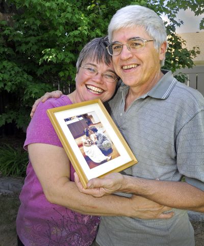 Andy and Jim CastroLang are United Church of Christ pastors who first met in the Catholic Church and then married. They hold their wedding day photo in the backyard of their south Spokane home July 15. (Christopher Anderson)