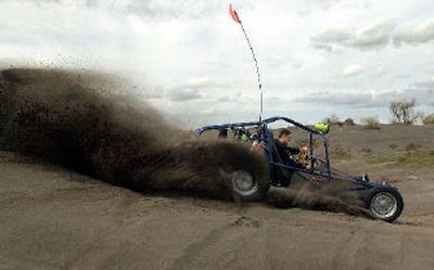 
Dune buggies and all-terrain vehicles are still allowed at the Moses Lake Sand Dunes ORV Area, but alcoholic beverages are not. Grant County banned drinking at the dunes to help reduce alcohol-related accidents.
 (File/ / The Spokesman-Review)