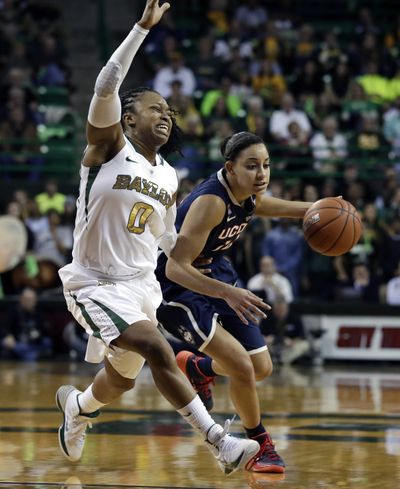 Baylor’s Odyssey Sims, left, tries to cut off a drive by Connecticut’s Bria Hartley in the first half of the top-ranked Huskies’ victory. (Associated Press)