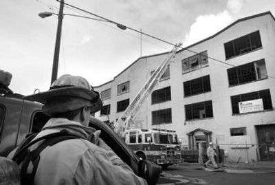 
The Spokane Fire Department fights  a blaze Tuesday near the corner of Third Avenue and Adams Street in Spokane. 
 (Dan Pelle / The Spokesman-Review)