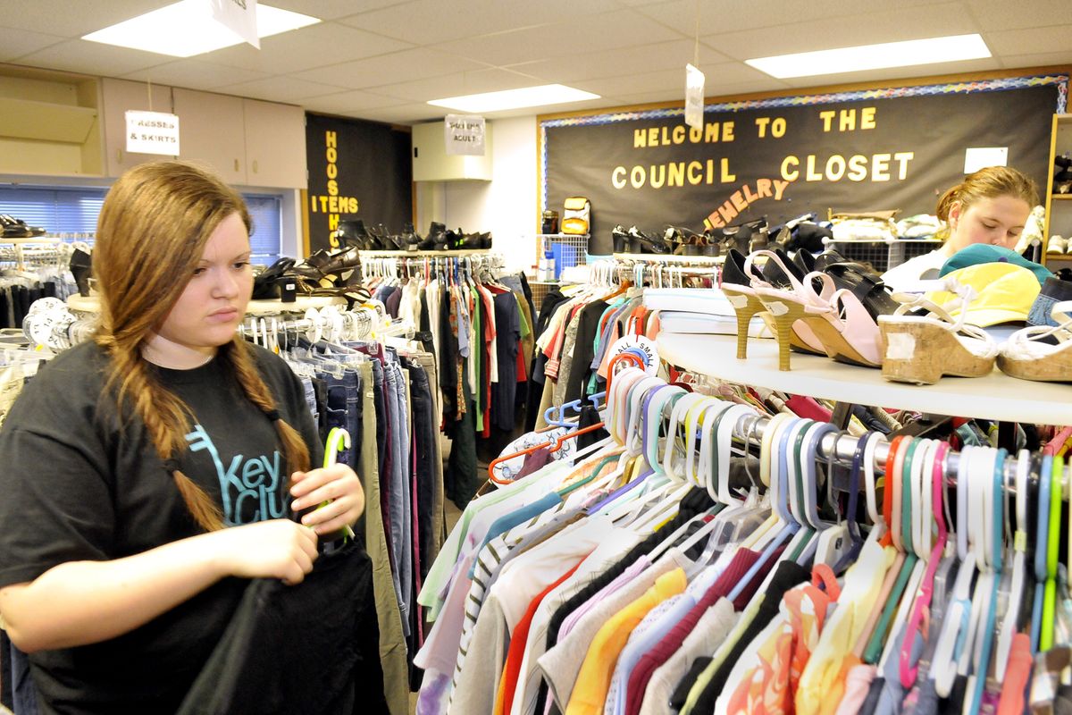 Volunteer Shannon Braithwait, left, puts out clothing at the Council Closet, a clothes bank at Barker High, on Wednesday. Students and their families can choose clothes from the donated items when the closet is open. (Jesse Tinsley)