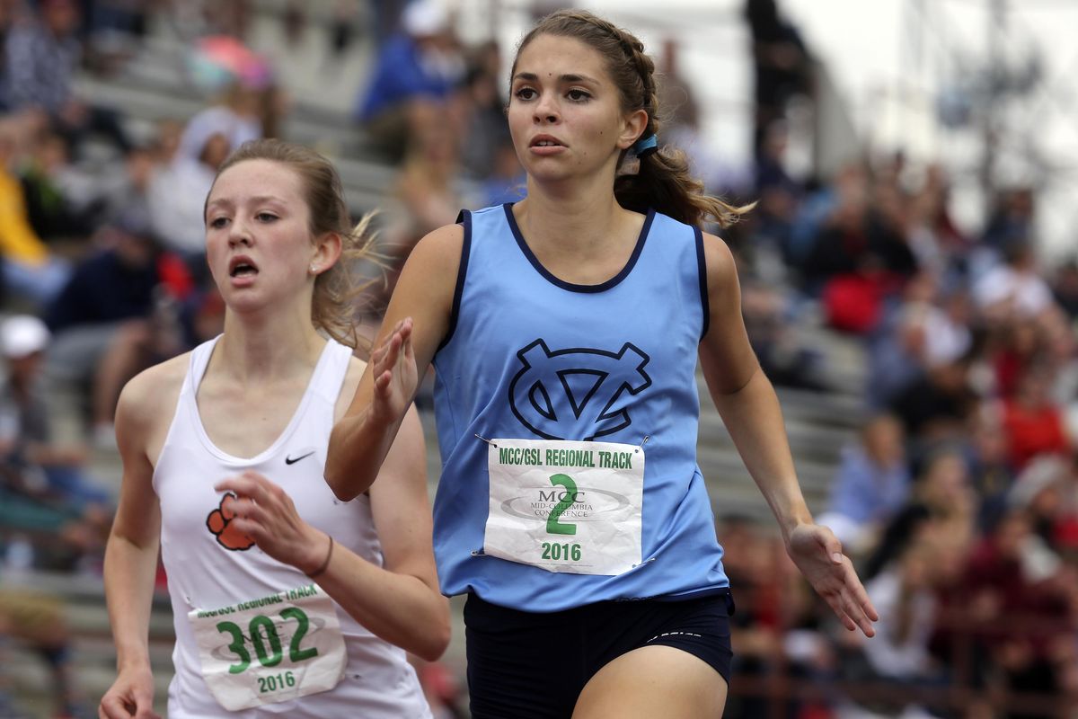 Central Valley’s Briegan Bester races Lewis and Clark’s Katie Thronson to the finish line in the 1,600 meters Saturday during the regional track and field championships at Fran Rish Stadium in Richland. Thronson won. (Sarah Gordon / Tri-City Herald)
