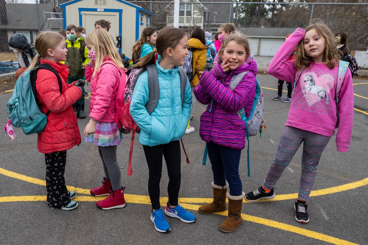 Roosevelt second-graders Evelyn Tesch, Greta Strunk, Maggie Byrne, Emmaline Shelton and Cora Magnum line up mostly maskless on the playground before school Monday.  (COLIN MULVANY/THE SPOKESMAN-REVI)