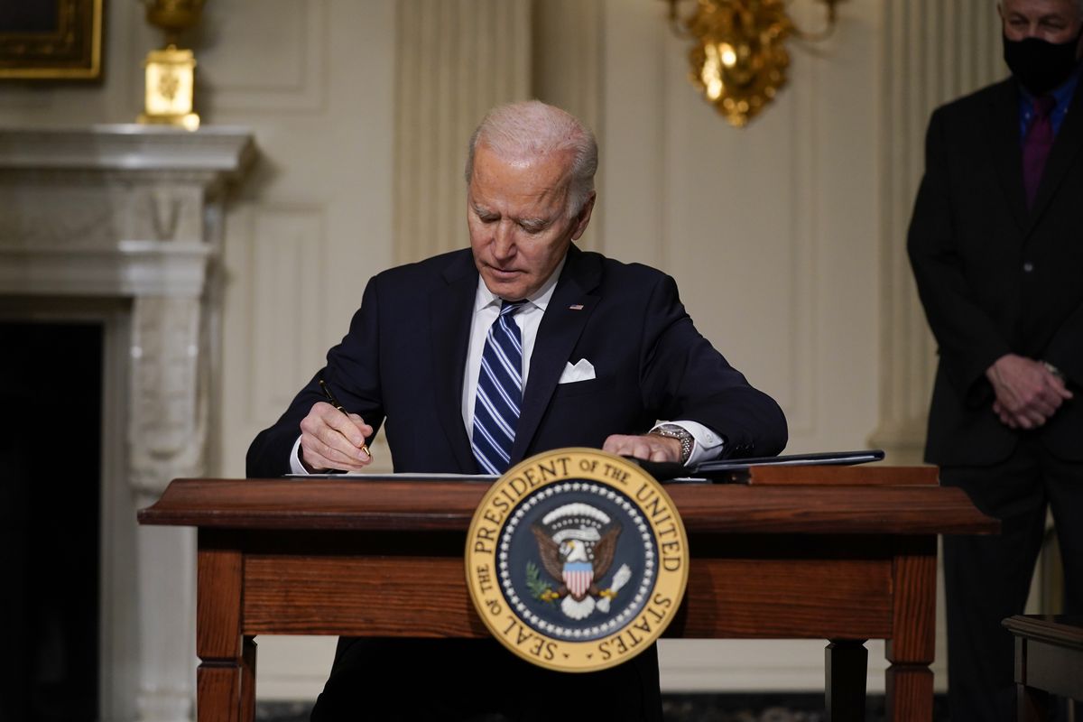 President Joe Biden signs an executive order on climate change, in the State Dining Room of the White House, Wednesday, Jan. 27, 2021, in Washington. (Evan Vucci)