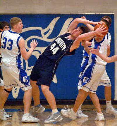 
Lake City's Nick Fromm tries to hang on to a rebound during the third quarter of the 5A district championship game against Coeur d'Alene in February 2007 at Coeur d'Alene High. 
 (File / The Spokesman-Review)