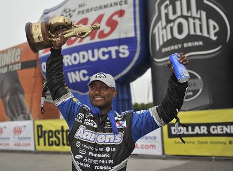 Antron Brown celebrates his St. Louis NHRA Top Fuel victory on the Full Throttle Drag Racing Series. (Photo courtesy of NHRA)