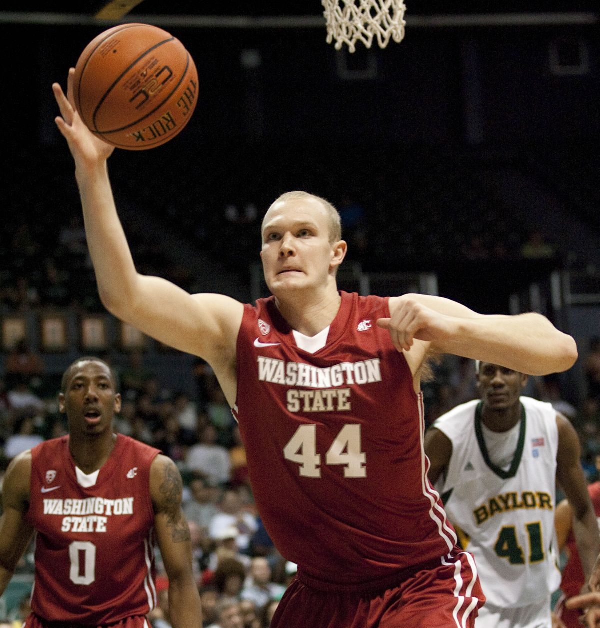 WSU forward Patrick Simon grabs a rebound in front of teammate Marcus Capers and Baylor’s Anthony Jones.  (Associated Press)