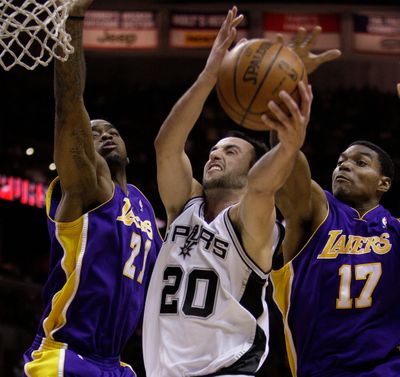 Lakers forward Josh Powell, left, and center Andrew Bynum try to slow down Spurs guard Manu Ginobili in NBA action on Wednesday. (Associated Press / The Spokesman-Review)