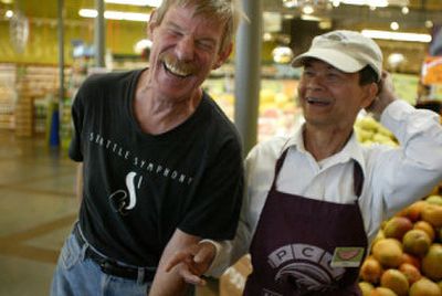 
Wesley Fisk, 61, left, a Vietnam veteran, and Thin Binh, 59, a former translator for Fisk during the Vietnam War, spend time together Wednesday at the Green Lake PCC grocery store in Seattle. The two men were reunited at the store, where Binh works. Fisk was shopping in the store when Binh recognized his voice. 
 (Associated Press / The Spokesman-Review)