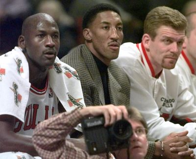 Chicago Bulls' injured player Scottie Pippen sits on the bench between teammates Michael Jordan, left and Joe Kleine in the first period against the Milwaukee Bucks on Dec. 5, 1997, in Chicago. (MICHAEL S. GREEN / AP)