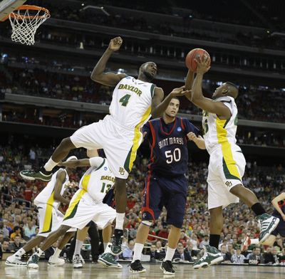 Baylor's Quincy Acy, left, and Tweety Carter, right, go for a rebound against Saint Mary's Omar Samhan during the first half of an NCAA South Regional semifinal college basketball game in Houston, Friday, March 26, 2010. (Eric Gay / Associated Press)