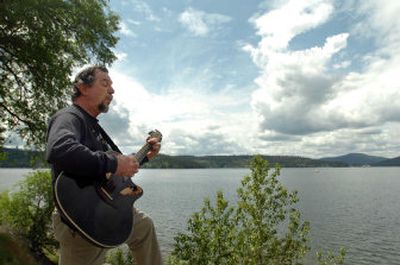 
Milt Briggs, of Sacramento, Calif., whistles and plays his guitar by Lake Coeur d'Alene on Thursday after arriving in Coeur d'Alene for  a whistling festival. 
 (Jesse Tinsley / The Spokesman-Review)