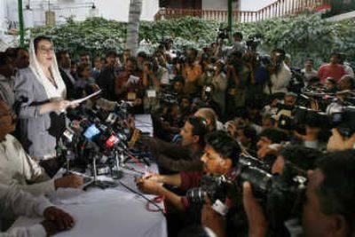 
Benazir Bhutto speaks the media at her residence in Karachi on Friday  after a suicide attack killed as many as 136 people. She blamed militants and said she would not 