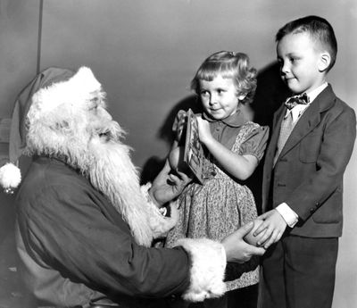 1953 - A Santa Claus greets children at a party.  (Photo Archives/spokesman-review)