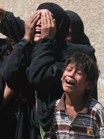 
An Iraqi family cries as they arrive to take the body of their relative from the hospital mortuary in Baghdad, Iraq, on Wednesday.
 (Associated Press / The Spokesman-Review)