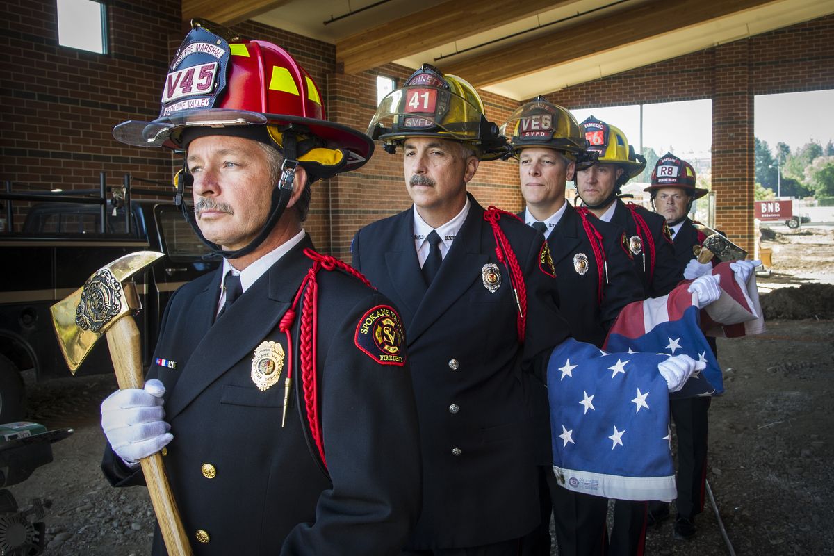 Members of the Spokane Valley Fire Department honor guard, front to back, Bill Clifford, assistant fire marshal; Greg Bennett, fire inspector; Dave Vegele, engineer/paramedic; Michael Fields, firefighter; and Tag Baugh, captain/paramedic, wait in the engine bay of Spokane Valley Fire Station 6, which is under construction, for a flag-raising ceremony Tuesday morning. The Spokane Valley Fire Department has a tradition of holding a dedication and flag-raising ceremony on Sept. 11 whenever the department has a building or station under construction. (Colin Mulvany)
