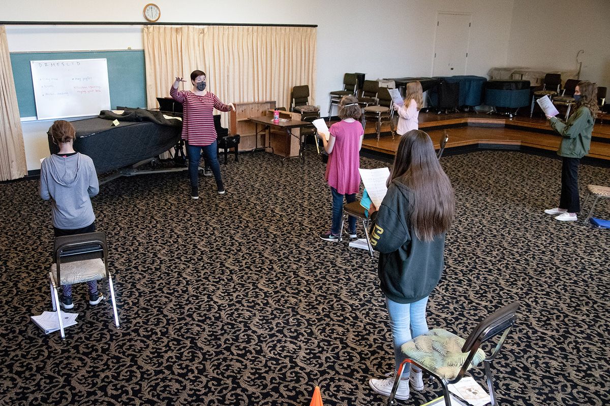 Members of the Crescendo Community Chorus, led by Artistic Director Stacia Cammarano, practice at Holy Names Music Center on Monday, March 22, 2021. The choir has stayed afloat during the pandemic by creatively adapting to challenges while social distancing and maintaining other health precautions.  (Libby Kamrowski/ THE SPOKESMAN-REVIEW)