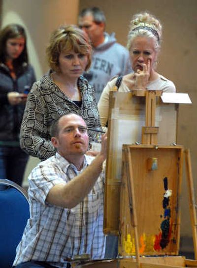 
Kyle Paliotto looks up from his painting.   Behind him are Cheryl Metcalf, left, and Elizabeth Greenelsh. 
 (Jesse Tinsley / The Spokesman-Review)