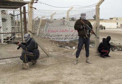 
Members of the Sunni Awakening council of Baqouba take positions after closing their offices, in Baqouba, Iraq, on Friday. Associated Press photos
 (Associated Press photos / The Spokesman-Review)