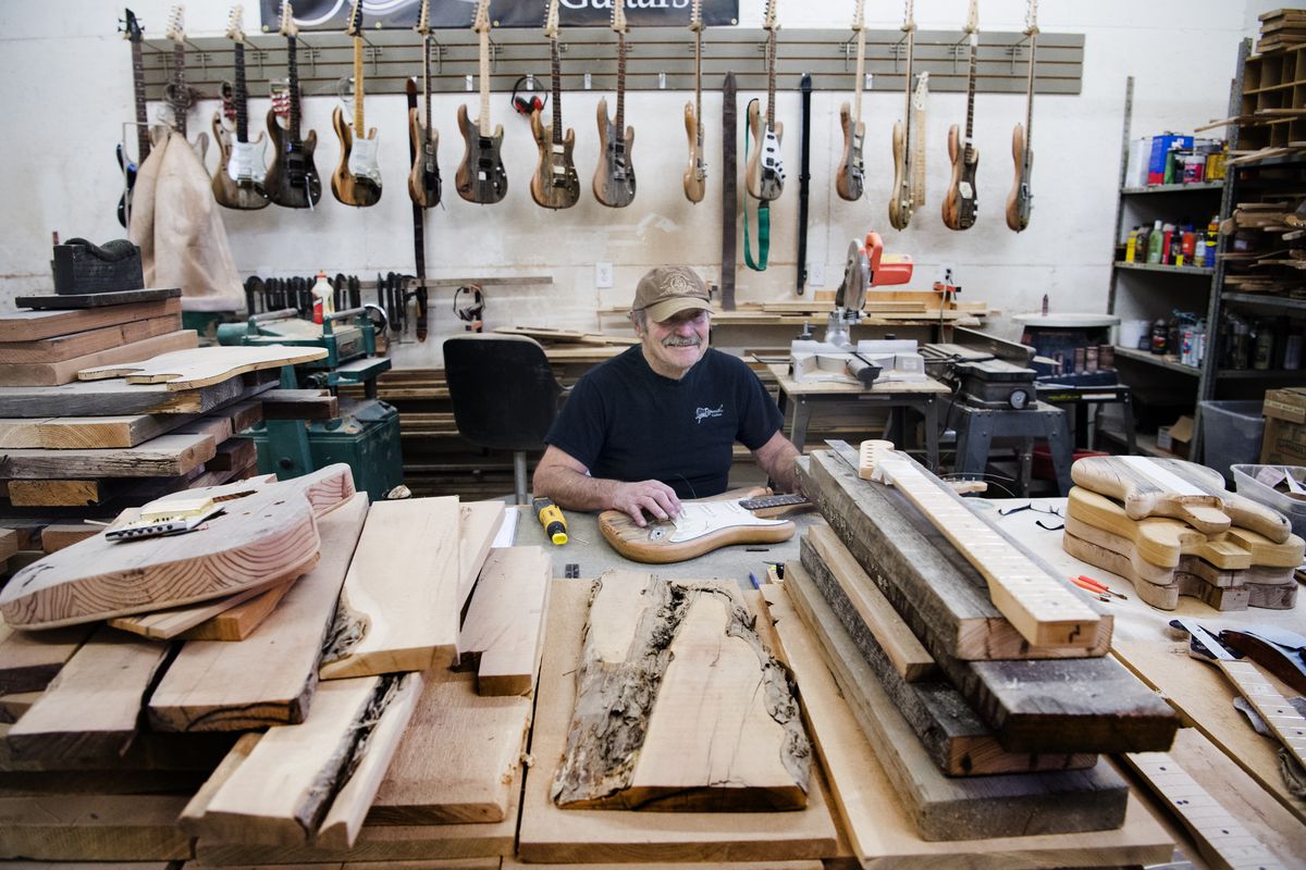Lynn Ellsworth poses for a photo with one of his custom guitars on Dec. 10, 2015, in his shop in Spokane.  (TYLER TJOMSLAND/The Spokesman-Review)
