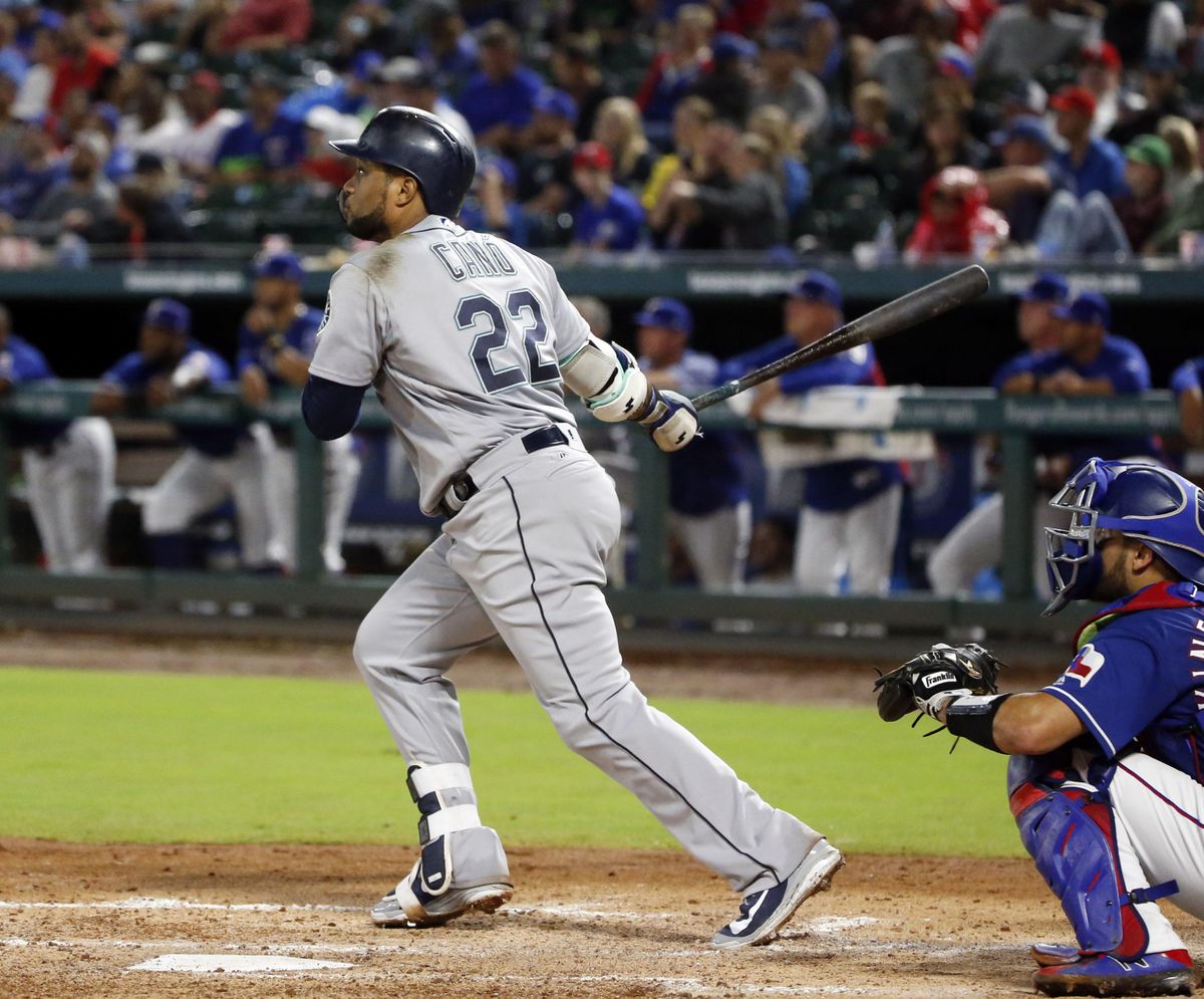 Seattle’s Robinson Cano watches the flight of his three-run home run against the Texas Rangers during the fifth inning Saturday in Arlington, Texas. (Michael Ainsworth / AP)