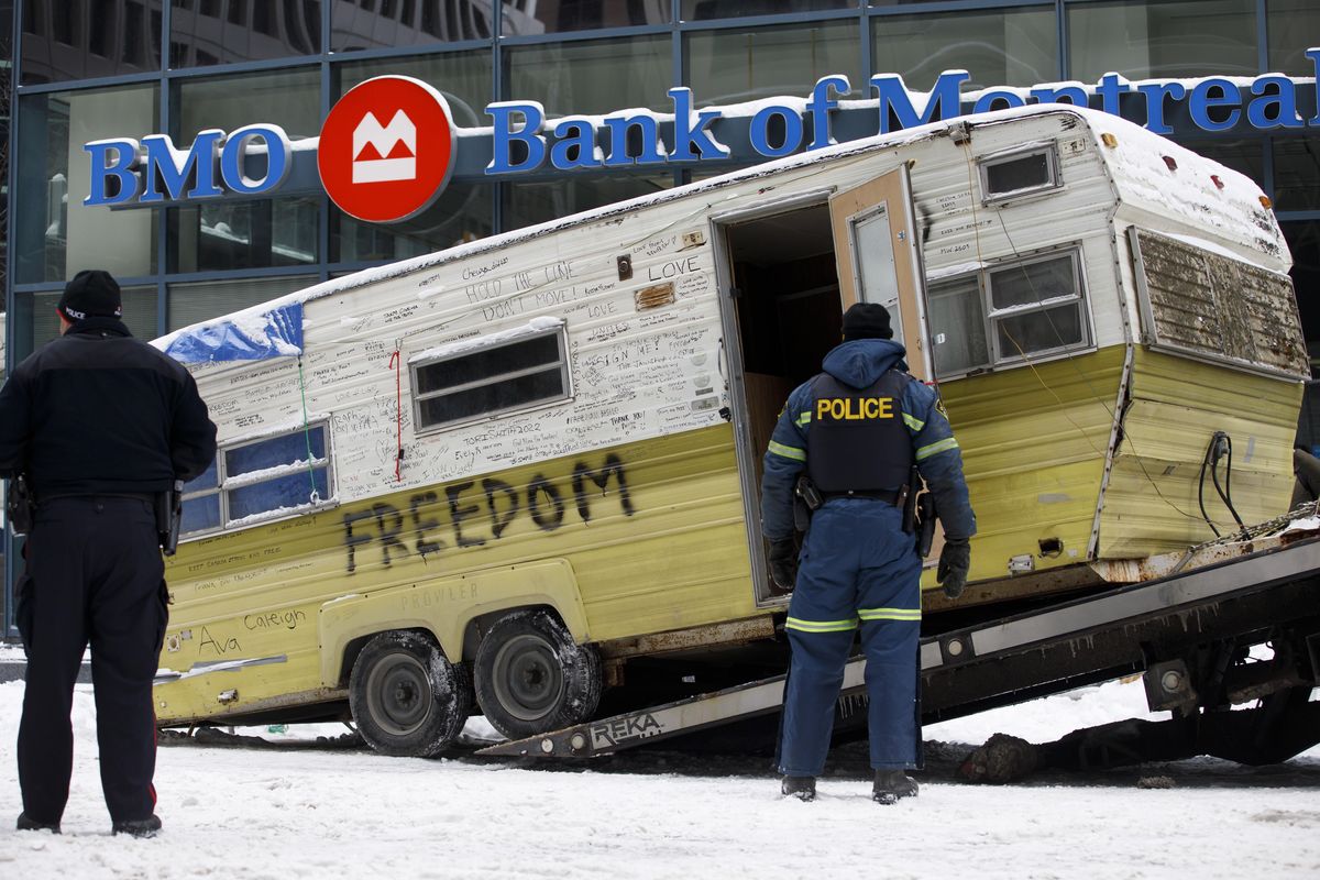 A camper is towed away by authorities clearing a trucker protest that was aimed at COVID-19 measures, in Ottawa, on Sunday, Feb. 20, 202.  (Cole Burston)