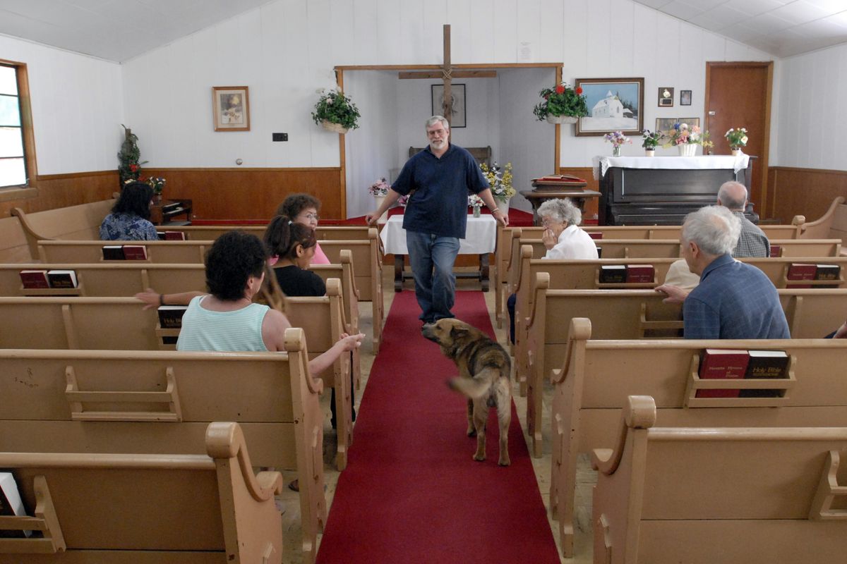 The Spokesman-Review “Dog is just God spelled backwards,” observed Tina Wynecoop as Buddy made his way into the final service at Wellpinit Presbyterian Church. (J. BART RAYNIAK / The Spokesman-Review)