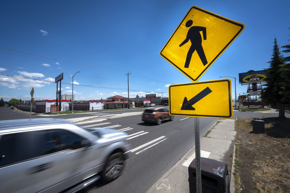 A Spokane man is suing the city and the driver of a car who struck him on Division Street. He alleges that the city was negligent in installing this mid-block crossing at Rhoades Avenue and Division without adding the proper precautions.  (Colin Mulvany/THE SPOKESMAN-REVIEW)