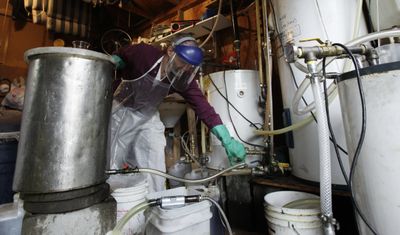 Lyle Rudensey refines biodiesel made from used cooking oil in his garage Wednesday in Seattle. Rudensey urges people who make their own fuel to take safety precautions.  (Associated Press / The Spokesman-Review)
