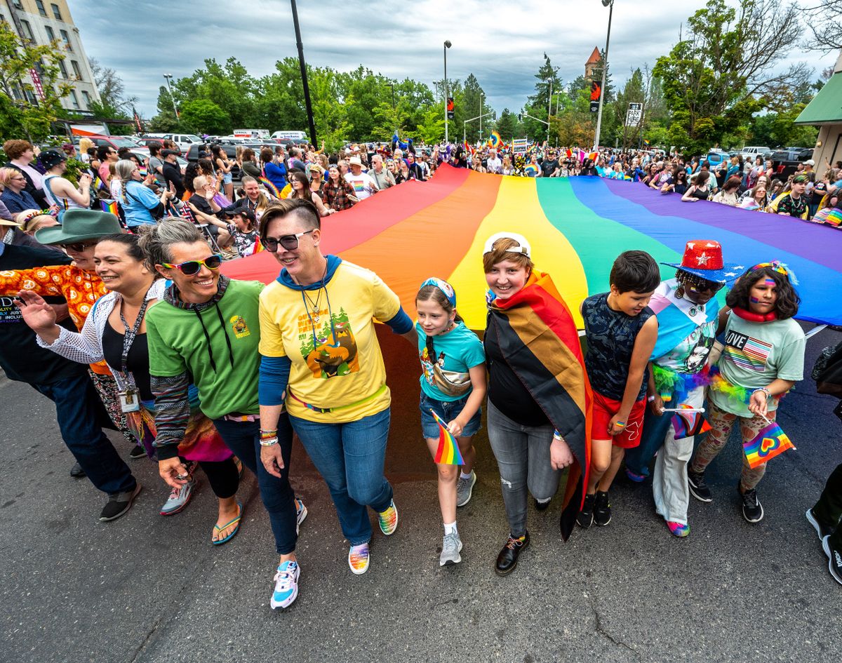 A large rainbow-striped Pride flag is carried by dozens of people during the 31st Spokane Pride Parade in downtown Spokane, Saturday June 10, 2023.  (COLIN MULVANY/THE SPOKESMAN-REVIEW)