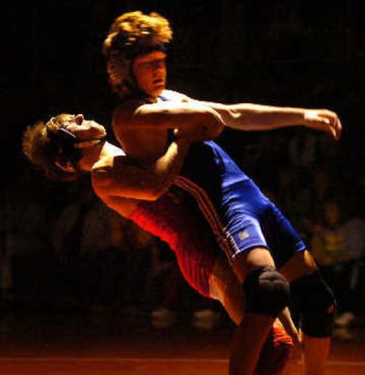 
Sandpoint's Timmy Pepperdine hoists Braden Mowry during Saturday's 103-pound final at North Idaho College that the Coeur d'Alene freshman won by registering a pin. 
 (Jesse Tinsley / The Spokesman-Review)