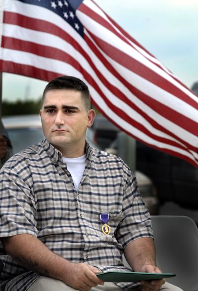 Michael Paccerelli listens as speakers honor him Friday after he received the Purple Heart for wounds he suffered in Iraq. The Colville resident has traumatic brain injury and severe hearing loss. (CHRISTOPHER ANDERSON  Spokesman-Review / The Spokesman-Review)