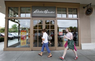 Shoppers walk past an Eddie Bauer store Wednesday in Seattle. Struggling retailer Eddie Bauer Holdings Inc. filed for Chapter 11 bankruptcy protection on Wednesday but said a bidder already has agreed to keep the majority of its 371 stores open, honor gift cards and hold onto most employees. (Associated Press / The Spokesman-Review)