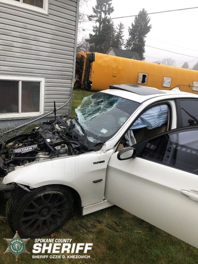 The driver of a stolen white BMW plowed into a school bus Monday in Otis Orchards, police said. Besides the bus driver, who did not appear to be injured, the school bus was unoccupied. The BMW driver, Jeffrey S. Schelin, was arrested later that day and taken to a hospital. (Courtesy of Spokane County Sheriff's Office)