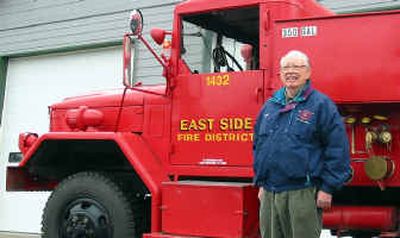 
Basil Mercer, a founding commissioner on the East Side Fire District board, stands next to one of the department's trucks. 
 (Photo courtesy of East Side Fire District / The Spokesman-Review)