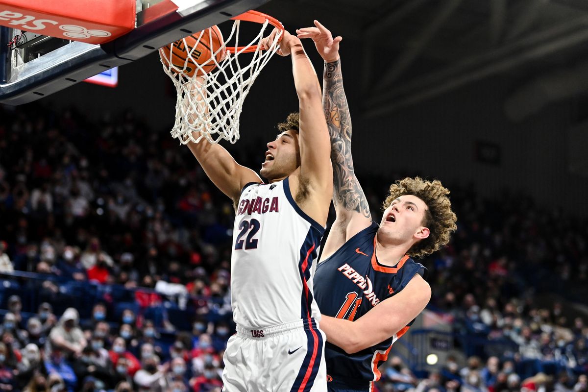 Gonzaga Bulldogs forward Anton Watson (22) dunks the ball against Pepperdine Waves center Carson Basham (11) during the first half of a college basketball game on Saturday, Jan 8, 2022, at McCarthey Athletic Center in Spokane, Wash.  (Tyler Tjomsland/The Spokesman-Review)